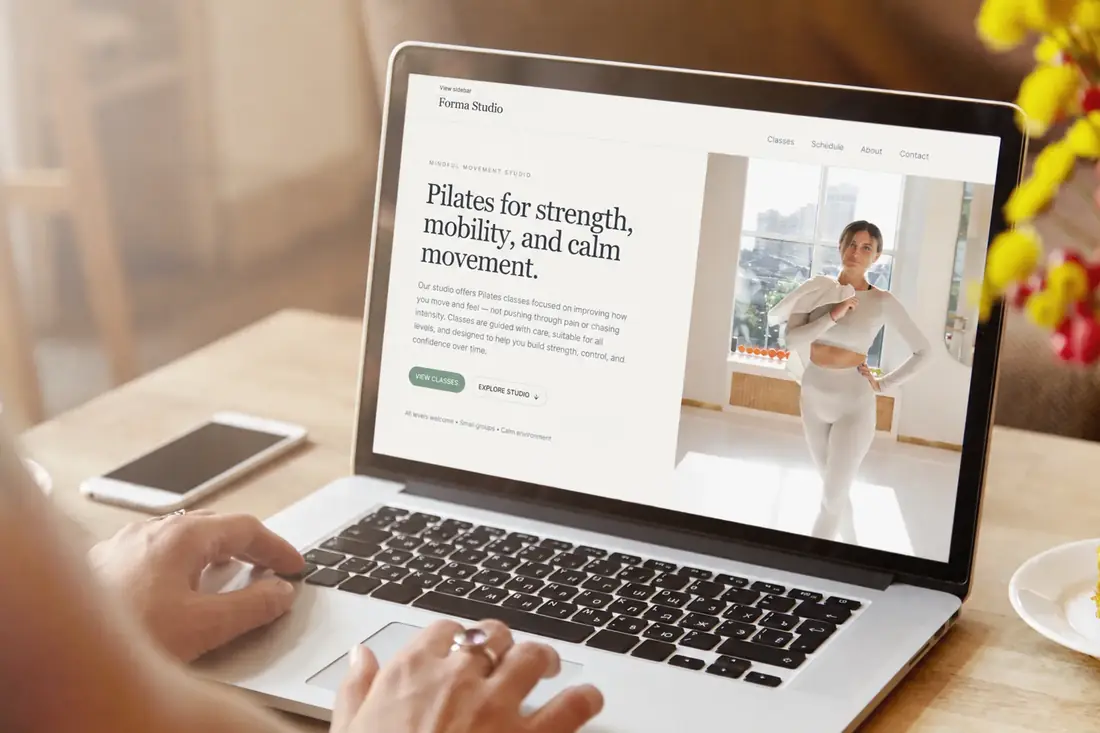 Modern fitness and beauty studio website design displayed on a MacBook